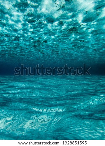 Underwater background with ripples and ripples in blue underwater