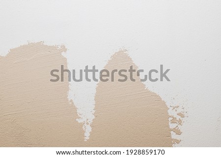 White beige cement texture stone concrete,rock plastered stucco wall. painted flat fade pastel background.decorative relief plaster on wall closeup.Copy space.selective focus