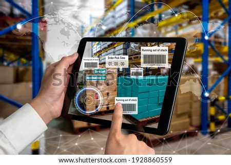 Smart warehouse management system using augmented reality technology to identify package picking and delivery . Future concept of supply chain and logistic business . Royalty-Free Stock Photo #1928860559