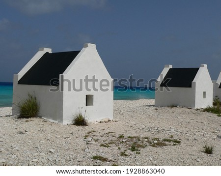 A closeup shot of white buildings on the rocky seashore