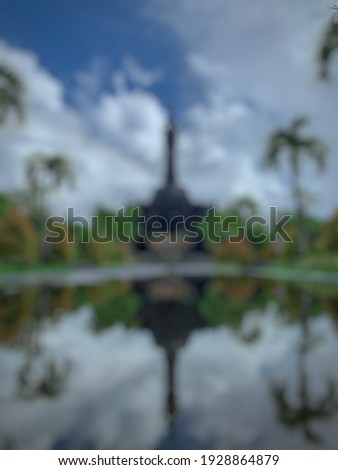Defocused abstact background of city park dan public square with a bell-shaped building and Balinese art style. Named "Puputan Margarana Renon" Park