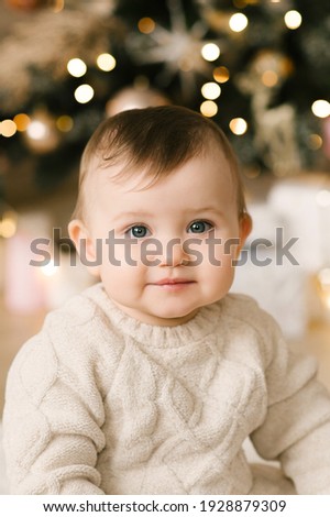 Little cute baby girl under the Christmas tree. Happy Holidays, Happy New Year. Christmas Time