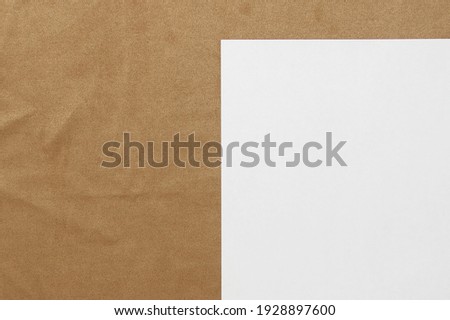 Template of white paper lies on light brown cloth background. Concept of business plan and strategy. Stock photo with empty space for text and design.
