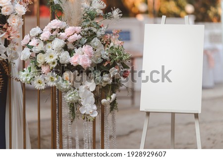 Empty white photo display board on stand for wedding arch. Royalty-Free Stock Photo #1928929607