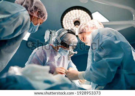 A team of surgeons is fighting for life, for a real operation, for real emotions. The intensive care team is fighting for the life of the patient. Saving life, the struggle for life Royalty-Free Stock Photo #1928953373
