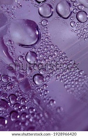 Colorful water drops beside the glass surface close up liquid drops modern background pattern high quality prints