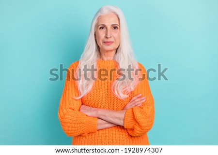 Portrait of attractive content calm grey-haired woman folded arms isolated over teal turquoise bright color background
