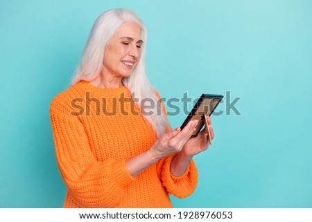 Photo of charming happy old lady look frame family picture remember smile isolated on pastel teal color background