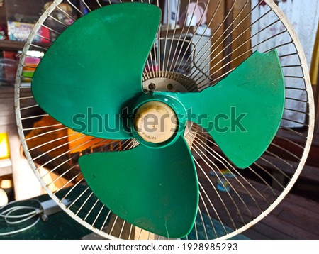an electric fan with one of its blades broken