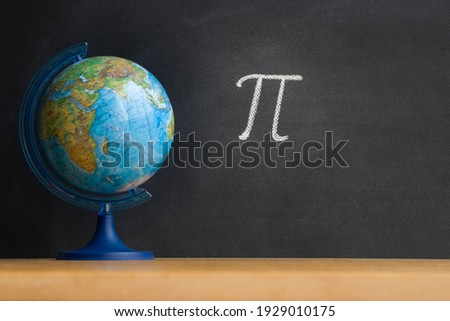 The Greek letter Pi, the ratio of the circumference to its diameter, is drawn in chalk on a black chalkboard in honor of the international number Pi for March 14 Royalty-Free Stock Photo #1929010175