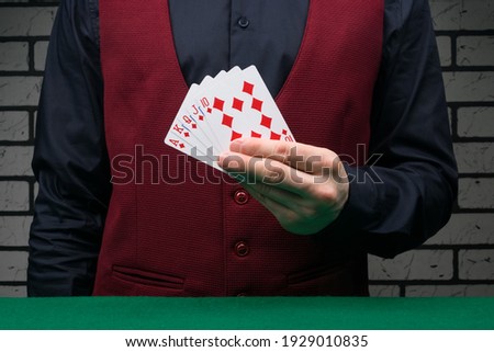 the croupier at the green table holds the winning combination of cards