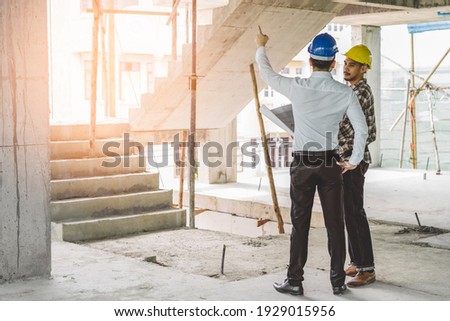 Asian contractor and engineer inspecting material in construction building. Royalty-Free Stock Photo #1929015956