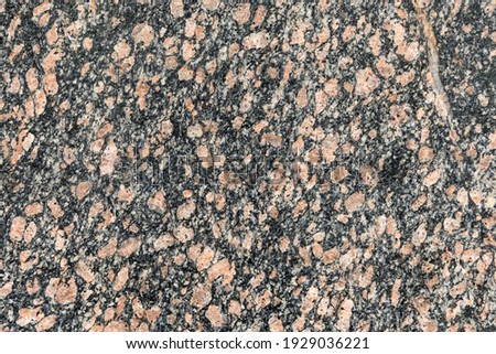 Granite texture, granite slab background, grey and red marble stone. Decorative element of old building fasade. Empty space for text.