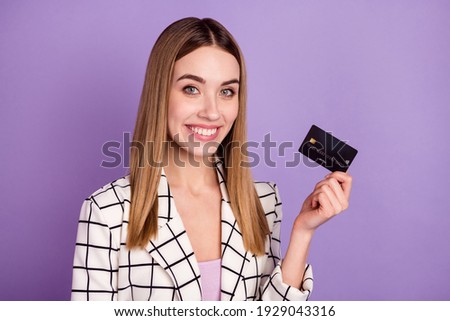 Photo of optimistic blond hair lady with card wear suit isolated on violet color background