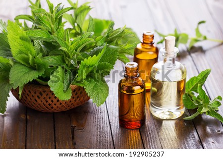 Essential aroma oil with peppermint  on wooden background. Selective focus, horizontal.