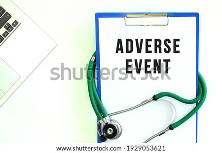 Stethoscope and clipboard with ADVERSE EVENT text on white sheet of paper.