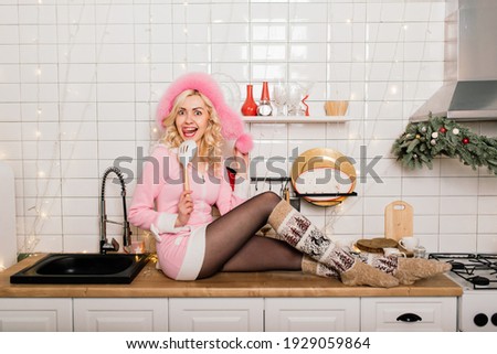 Young blonde housewife preparing christmas dinner in kitchen