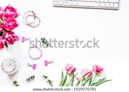 Flowers on trendy desk in office white background top view mock up