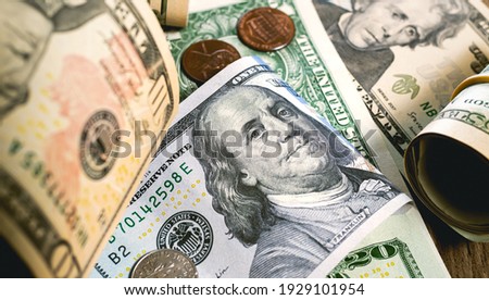 Dollar bills and coins scattered on the desk. Us Money - USD. Photography for Finance and Economy concepts.  Royalty-Free Stock Photo #1929101954