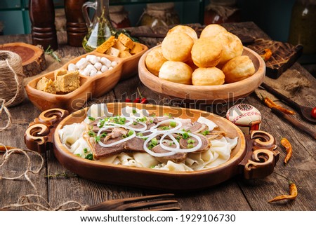 Kazakh traditional dish beshbarmak with horse meat and boiled dough Royalty-Free Stock Photo #1929106730
