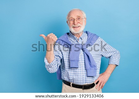 Photo of optimistic old grey hairdo man point empty space wear spectacles blue shirt isolated on pastel color background Royalty-Free Stock Photo #1929133406