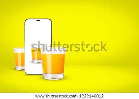 White screen smartphone with a picture of orange juice and two glasses of orange juice on yellow background with copy space. 