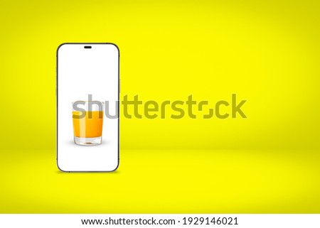 White screen smartphone with a picture of orange juice on a yellow background with copy space. 