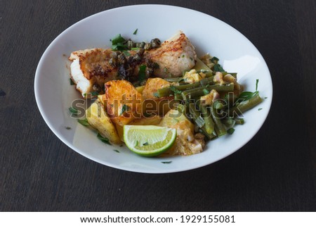 Baked white cod fish, bacalhau, with roasted potatoes and simple skillet green beans