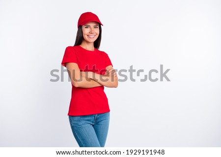 Photo of young happy cheerful smiling lovely delivery service woman with crossed arms isolated on grey color background Royalty-Free Stock Photo #1929191948