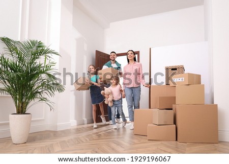 Happy family with children moving into new house Royalty-Free Stock Photo #1929196067