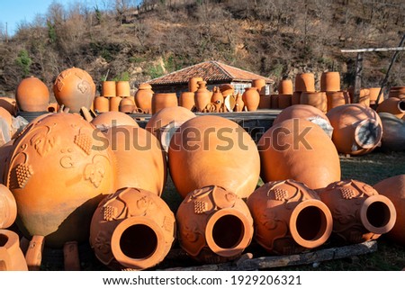 Georgian traditional ceramic jugs kvevri for wine, outdoor trade Royalty-Free Stock Photo #1929206321