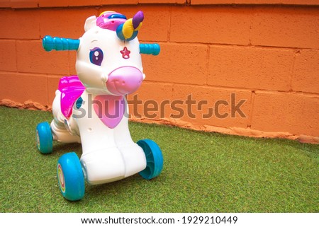 White toy unicorn with wheels