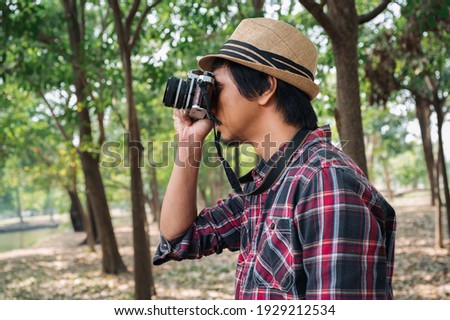 man with camera vintage in forest
