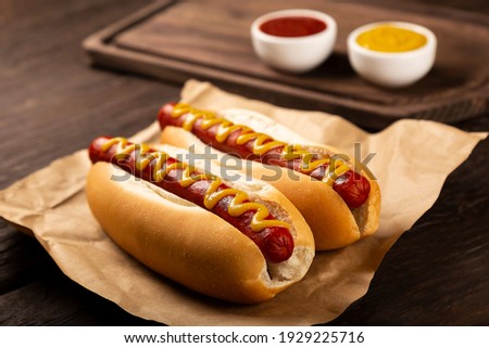 Hot dog with ketchup and yellow mustard. Royalty-Free Stock Photo #1929225716