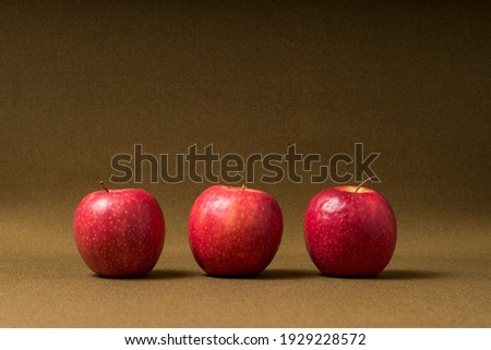 Three red apples in a row. Health is important, good for the body. Red the color of love. Good food, enjoy a spiky apple