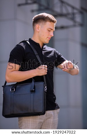 Young  business man in classic look walking on the street with Briefcase Designer Leather Laptop Satchel Portfolio Messenger Bag.  different color of bag and no logo.