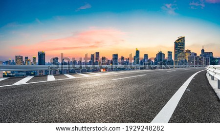Empty asphalt road and city skyline with buildings at sunset in Shanghai. Royalty-Free Stock Photo #1929248282