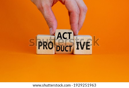 Proactive and productive symbol. Businessman turns cubes and changes the word 'productive' to 'proactive'. Beautiful orange background, copy space. Business, proactive and productive concept. Royalty-Free Stock Photo #1929251963