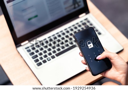 Phone password lock for mobile cyber security or login verification passcode in online bank app. Data privacy and protection from hacker, identity thief or cybersecurity threat. Laptop and smartphone. Royalty-Free Stock Photo #1929254936