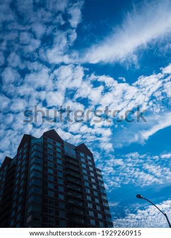 Cumulous Clouds over the Silhouette Building