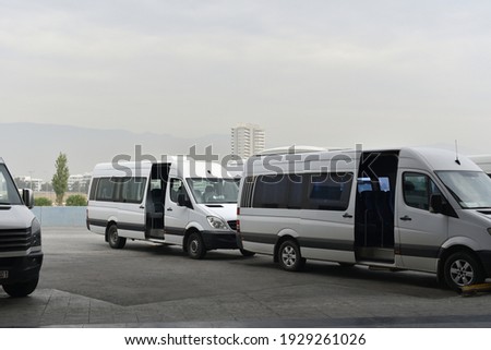 minibuses with open doors on city bus station Royalty-Free Stock Photo #1929261026