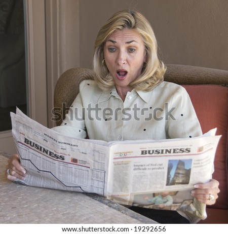 Mature woman reading the financial news