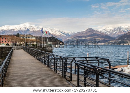 The lakeside promenade of Colico with the snow-capped Alps in the background