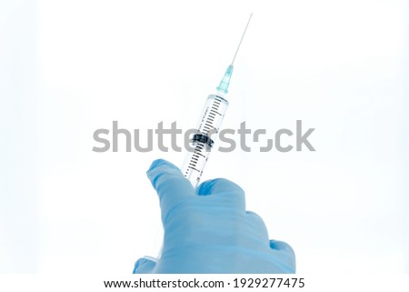 isolated on white background: doctor's hand in glove holds a syringe vaccination against covid concept.
