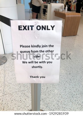 A laminated sign instructs people that this is the exit only.
