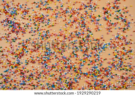 Mix of colorful Sugar balls powder background with space for text. Holiday background. Top view