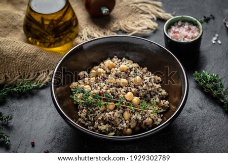 Close-up view of bowl of quinoa salad with chickpea. Buddha bowl with quinoa, chickpeas and thyme. Super food, Food recipe background. top view.