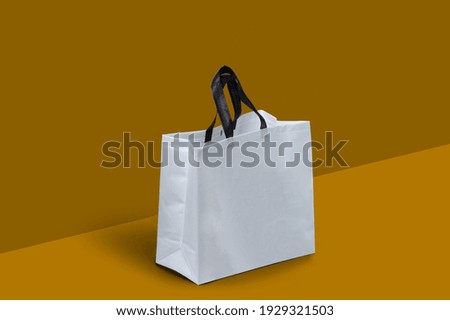 White Fabric Non Woven Box Bag Mockup on dark yellow background. Copy Space for Text and Logo. Eco Friendly Concept. white shopping grocery shopper isolated yellow background. empty kraft bag Royalty-Free Stock Photo #1929321503