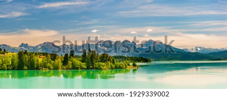 panoramic landscape in Bavaria with mountain range and lake Royalty-Free Stock Photo #1929339002