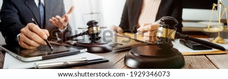 justice and law concept. Male judge in a courtroom on wooden table and Counselor or Male lawyer working in office. Legal law, advice and justice concept.
